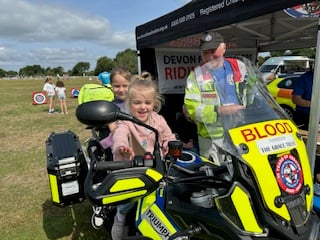 The volunteer bikers Devon Freewheelers show young visitors to the Yelverton Fun Day their motorbikes. The riders courier blood and other emergency medical products for the NHS. Picture by Nigel Tigwell.