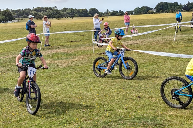 Mini-mountain bikers from Dartmoor Velo get competitive at Yelverton Fun Day on the airfield. Picture by Dartmoor Velo.