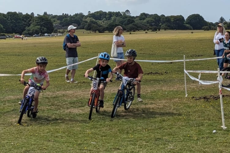 Mini-mountain bikers from Dartmoor Velo get competitive at Yelverton Fun Day on the airfield. Picture by Dartmoor Velo.