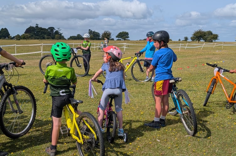 Mini-mountain bikers from Dartmoor Velo get competitive at Yelverton Fun Day on the airfield. Picture by Dartmoor Velo.