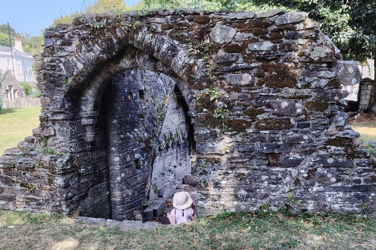 Finding shade among the historic Tavistock Abbey ruins with a hat on is an ideal way to stay out of the sun during a summer heatwave.