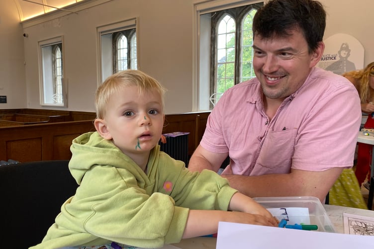 Minty Penrose enjoying colouring in some mining-themed pictures with dad Dickie at a summer holiday activity event in Tavistock Guildhall courtroom organised by Tavistock Heritage Trust's discovery team. There are more Wednesday activities on offer. until August 27.