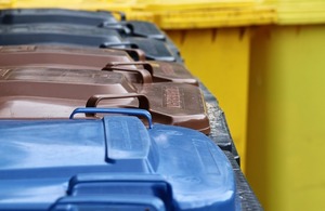 Household bins lined up outside.
