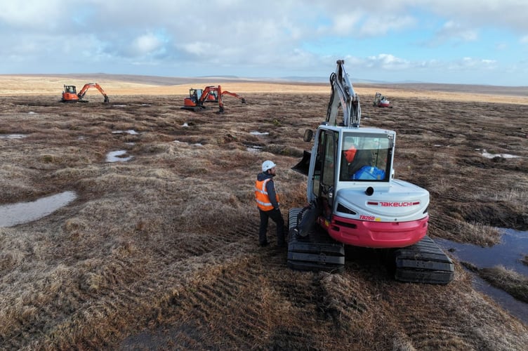 George, Project officer, chatting with contractors out on site on Dartmoor.