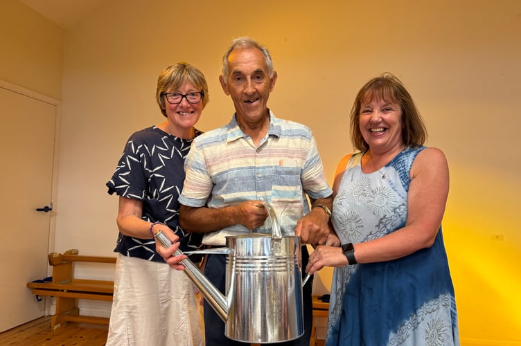Cleave Collins was presented with an engraved watering can for supporting and competing at the Spreyton Show for 50 years by Show Treasurer Angela Hawkins, left and Show Secretary Sharon Hawking. AQ 0444