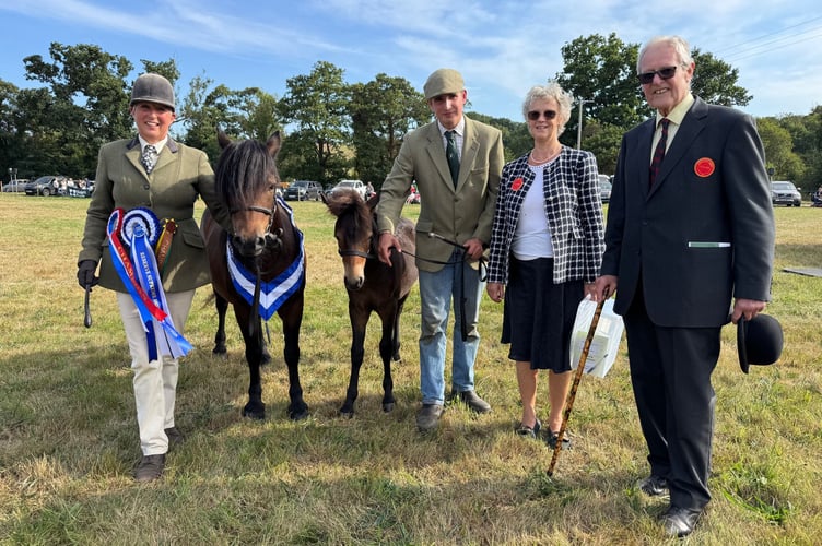 Reserve Champion was a Dartmoor mare, Moortown Honeymoon with foal, owned by John Jordan of Gidleigh. Left to right are Rebecca and Jack Jordan with judges Caroline Bailey and Richard Vice. AQ 1132