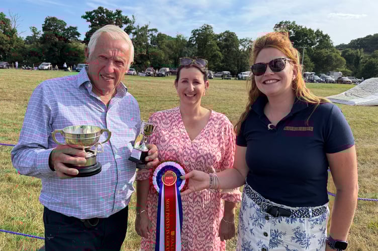 John Jordan gained the Most Points at Chagford Show, pictured receiving a trophy from Show Secretary Tiggy Fuller, centre and sponsor Rosie Ware from Ruralis Insurance. AQ 1143