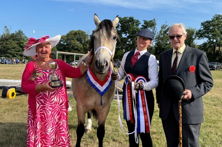 Chagford Show President Pam Shilston presented the Supreme Horse Show trophy to Millie Logan from near Okehampton who won with Penlangrug The Democrat, a 9-year-old Section D, Right is judge, Richard Vine. AQ 1117