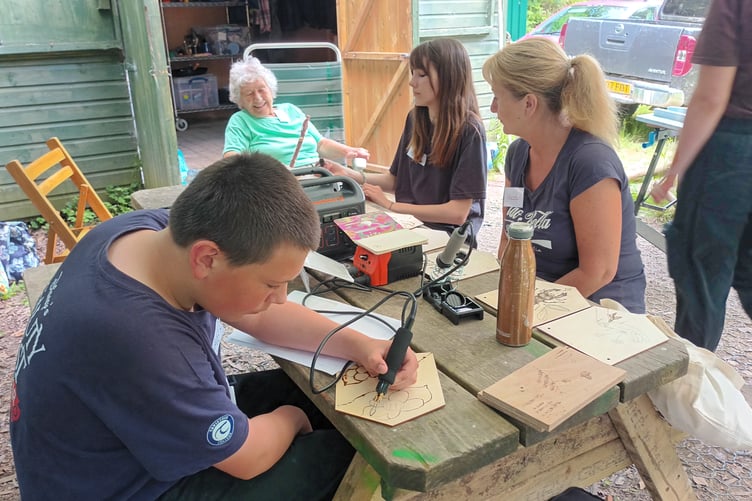 Tavistock Youth Cafe members with a fellow guest from Tavistock Memory Cafe on an 'away day' to share practical skills and memories. Picture by Heather Rayner.
