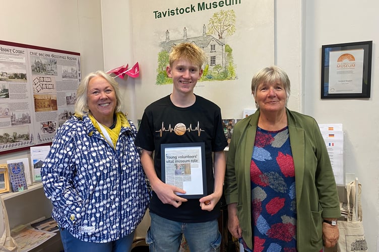 Tavistock Museum young volunteer receives thank you gifts from manager Lesley Holliday and volunteer Gaby Jones.