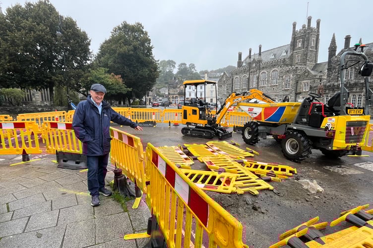 Local businessman John Taylor points to the big hole in Tavistock town centre where gas main upgrades are taking place. Picture: Alison Stephenson