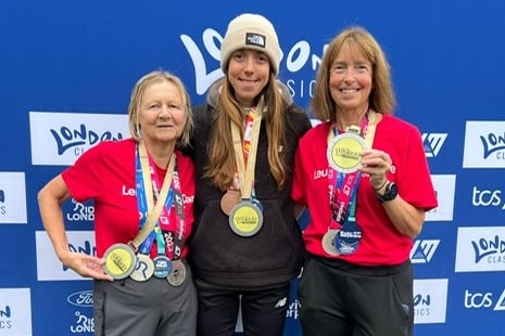 Linda Trebilcock, left, and friend Helen Smith, right, with Helen's daughter Hannah proudly show off their cycling, running and swimming medals - having just finished the two-mile Serpentine Swim - to claim their three London Classics events.