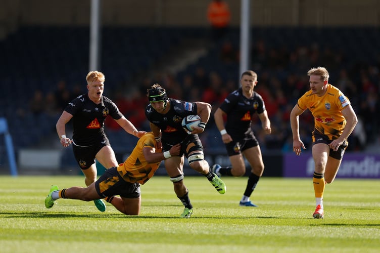 Exeter Chiefs No.8 Ross Vintcent looks to find a way through the Newcastle Red Bulls defence
