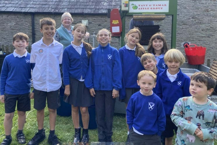 Buckland Monachorum school pupils learning all about the art of apple pressing.