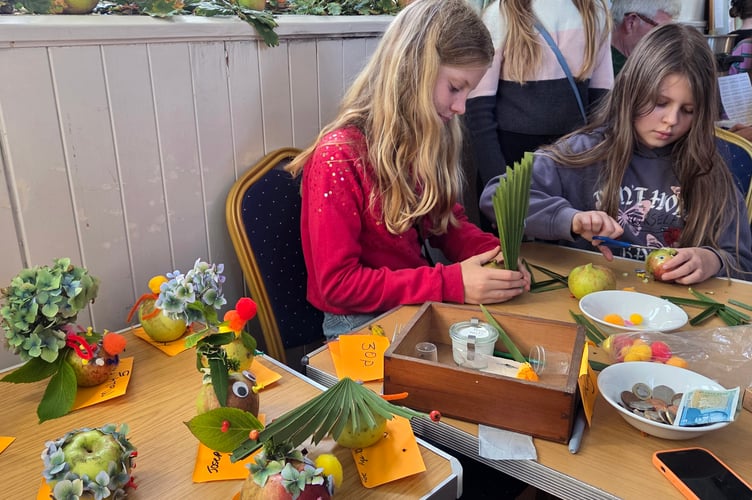 Creative youngsters making some happy apple faces at Bere Applefest. Picture by Ann Parsons.