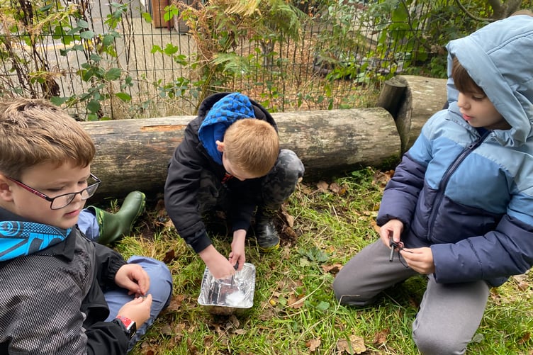 Sparking a campfire during outdoor skills lessons at Horrabridge School.