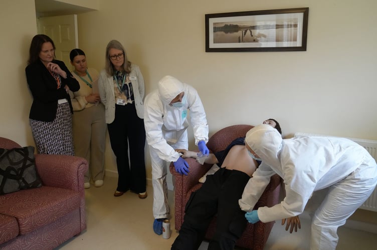 Alison Hernandez observing students at the university's crime scene house.