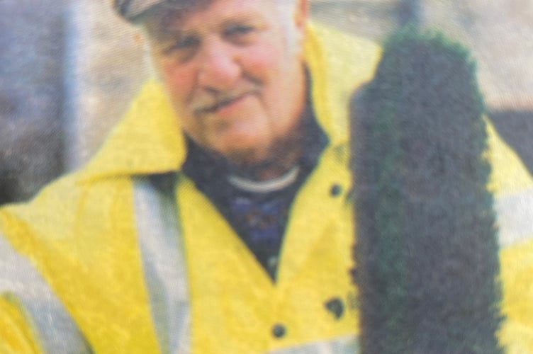 The late Stuart Cole with his familiar street cleaning uniform and broom.