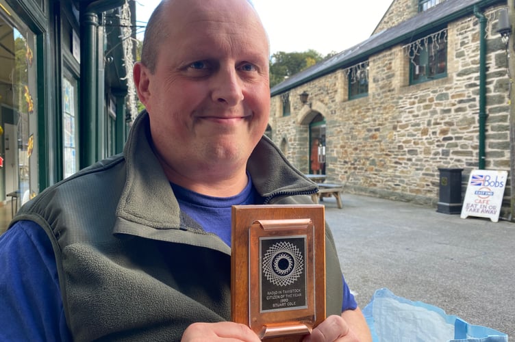 Dale Cole proudly holds up his late father Stuart's 'Radio in Tavistock Citizen of the Year Award 1990'.