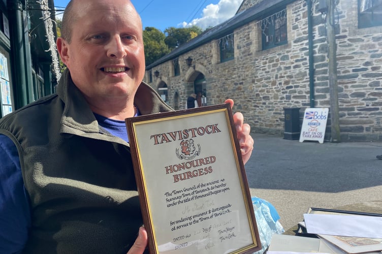 Dale Cole proudly holds up his late father Stuart's Tavistock Town Council Honoured Burgess title in 2005 for 'rendering and distinguished service to the town..