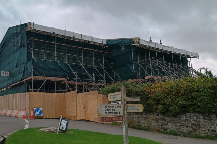The scaffolding covering the thatched cottages at Drewsteignton which are due to be rebuilt after a fire.