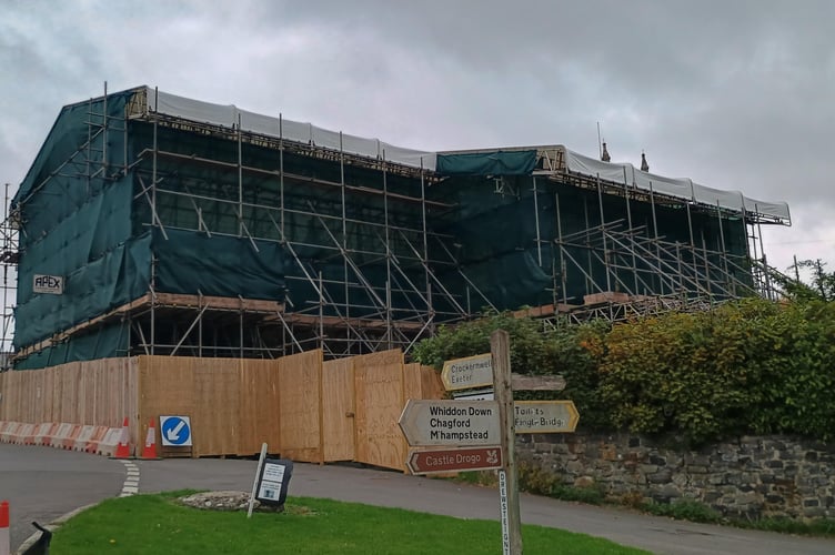 The scaffolding covering the thatched cottages at Drewsteignton which are due to be rebuilt after a fire.