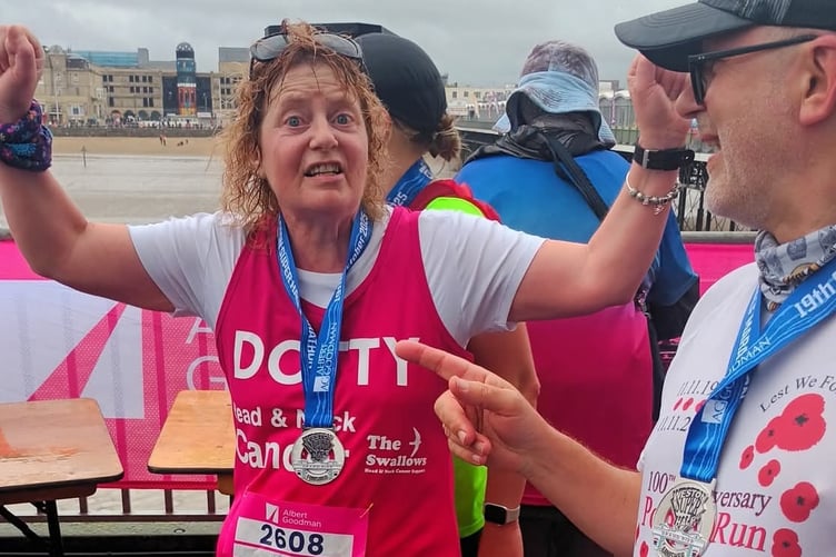 Dotty King celebrating after completing the Weston-Super-Mare half marathon in aid of the Head and Neck Charity after surviving cancer herself.