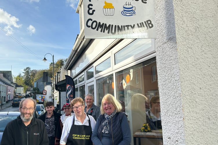 The launch of the new Pop-In Cafe and Community Hub in Gunnislake – a dream come true for founder Ruth Kelly-Williams, centre, and her fiance Andrew Cuer, back right. Also pictured, from left, signwriter Chris Clarke (left) and his wife, Gunnislake ward parish councillor, also Chris Clarke, right, who did the cafe flowers. Cutting the ribbon was Cornwall councillor for Calstock Angus Black (back left, Reform UK), while Calstock town crier Hilary Fairhurst, back in her regalia, performed a special 'cry' in honour of the occasion.