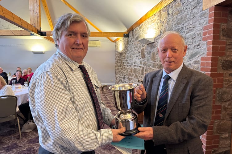 Peter Stone, left, receiving the Devon County Champion Ploughman award for 2025 from President Raymond Govier.  AQ 7123
