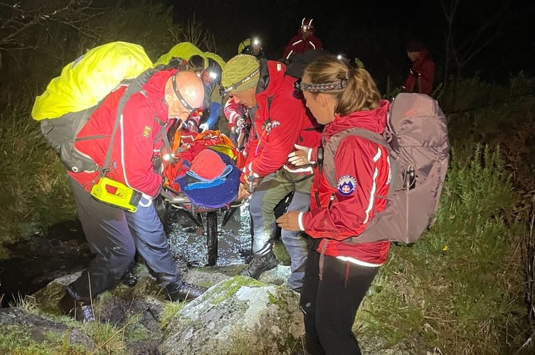 Team members extracting the walker near the river.
