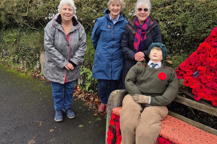 Whitchurch WI members with their charming remembrance tribute poppy bench and model wartime land girl.