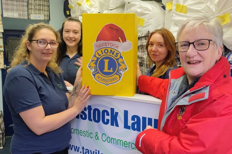 The distinctively yellow Tavistock Lions Christmas charity post box at Tavistock Launderette.