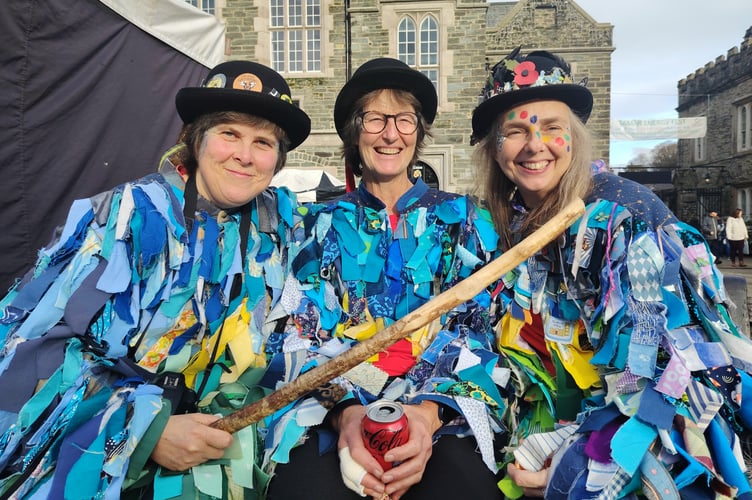 Three morris dancers rest during the Pudsey Day of Morris fundraising festival.