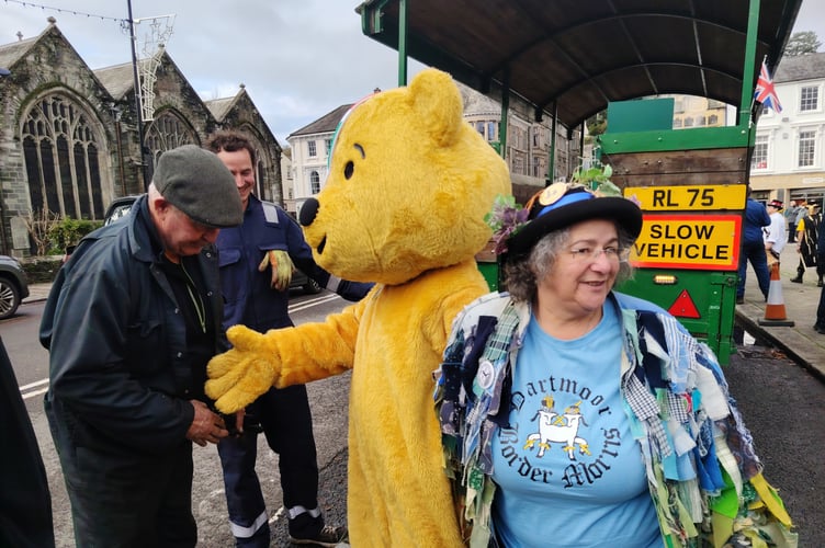Pudsey Bear joins a Dartmoor Border Morris member on a Robey Trust steam engine at the Pudsey Day of Morris in Tavistock.