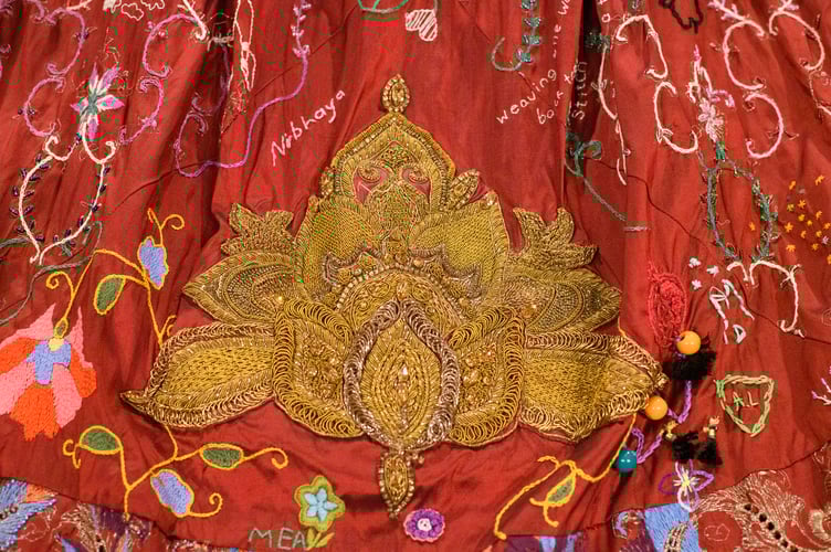 Detail of a sensational red dress, with Somerset creator Kirstie Macleod, is on display at Christmas at NT Killerton House, near Exeter, from Saturday, November 29. Picture by Steve Haywood.