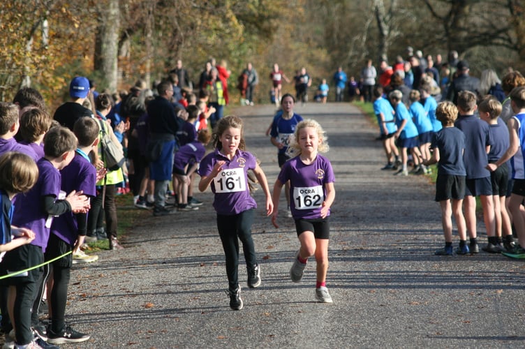 Cross country runners, Mary Tavy and Brentor School pair put in a sprint on the road to Castle Drogo.