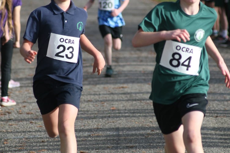 A Chagford and a North Tawton runner fighting to the last at Castle Drogo cross country. Picture by Mhairi McCall.