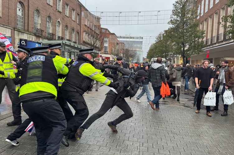 Police attempt to stop a protester before he was handcuffed.  AQ 8788
