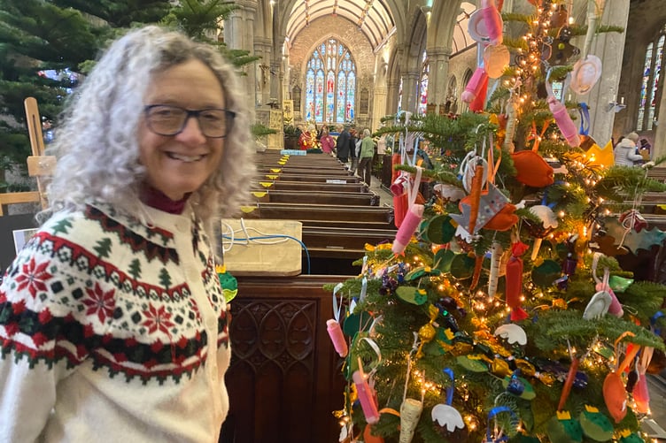 Vanessa Bowles, organiser of Tavistock Christmas Tree Festival. She is pictured next to a particularly poignant tree decorated in memory of popular Tavistock College teacher xx Stroud who died recently. He was famous for his Christmas spirit and sprout suit.
