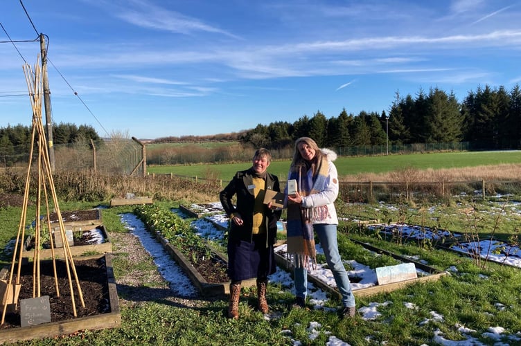 Prize-winning 'plotters of Princetown community garden The Plot receive a national award.  Pictured left to right:  Geraldine King, RHS estates services manager, presents the Britain In Bloom Community Award to Hazel Williams.