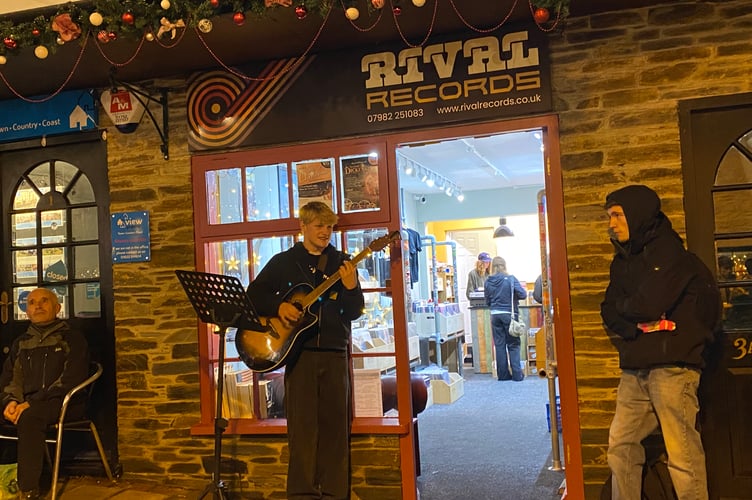 Tavistock Dickensian Evening - a Tavistock College student entertains the crowds on Paddons Row.