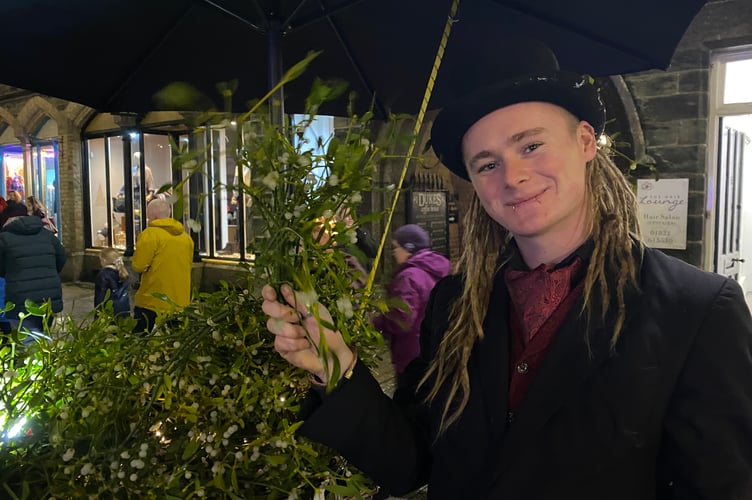 Tavistock Dickensian Evening - selling romance with seasonal mistletoe.