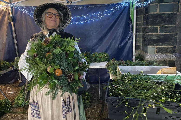 Tavistock Dickensian Evening - a wreath seller and maker in period dress.