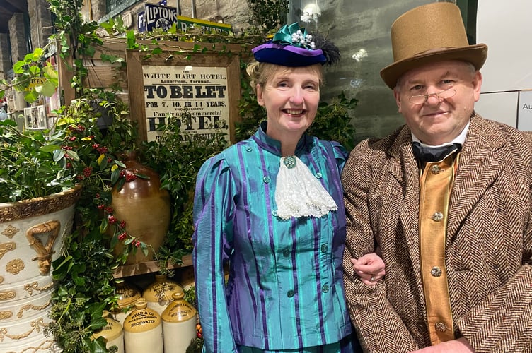 Tavistock Dickensian Evening - entering into the nostalgic spirit are a pannier market husband and wife trader team.