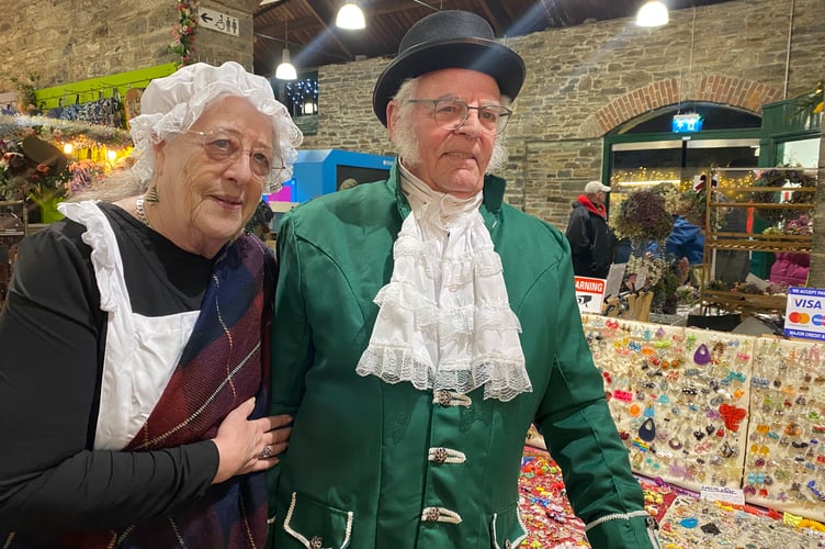 Tavistock Dickensian Evening - entering into the nostalgic spirit is a pannier market trader team.