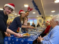 Charity festive lunch served by college students