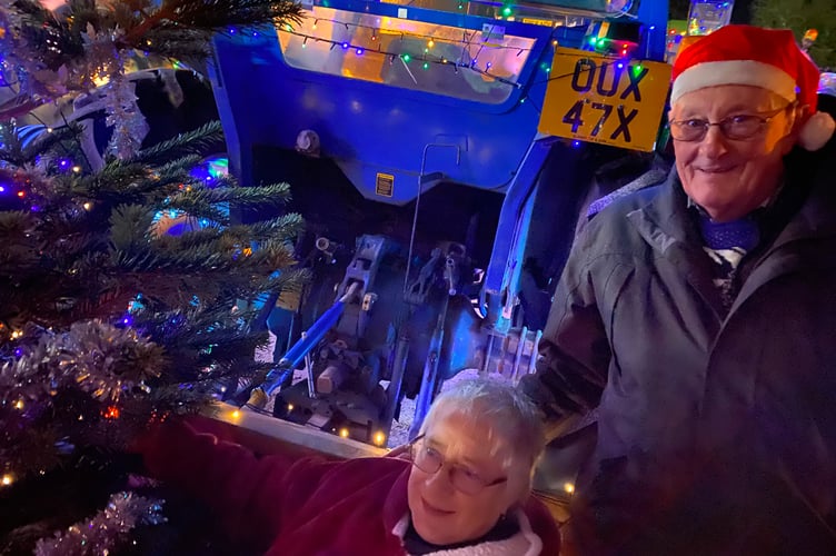 Tavistock AFC festive tractor run farming pair in Santa outfits.
