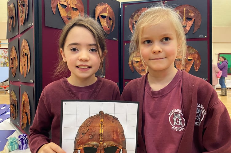 Scarlett, 8 and Astrid, 8, show their Sutton Hoo inspired mask art (left to right). Their  work was on display at Horrabridge School young artists' show at the school's first ever exhibition.