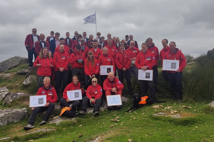 The north Dartmoor team with Hatherleigh Silver Band at their fundraising concert for the team on top of Sourton Tor in July 2023.