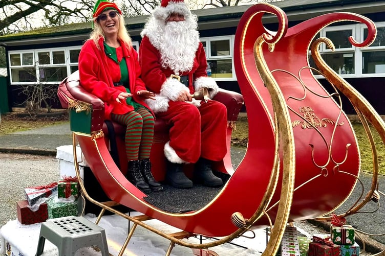 Santa and elf on his sleigh bringing joy to schools, thanks to Tavistock Lions. Picture by Paul Rimmer, of Tavistock Lions.